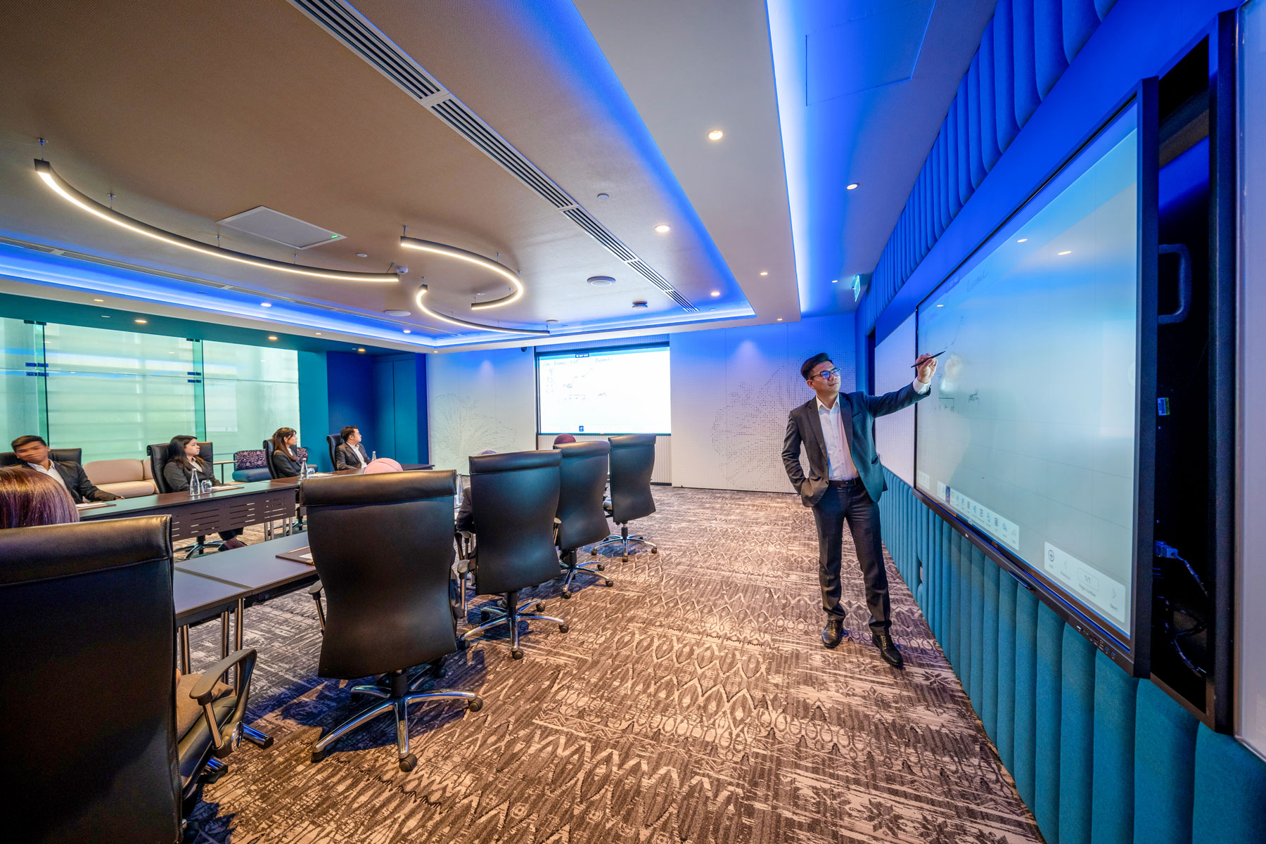 Modern high-tech conference room with presenter and attendees, ideal for business conventions and professional meetings