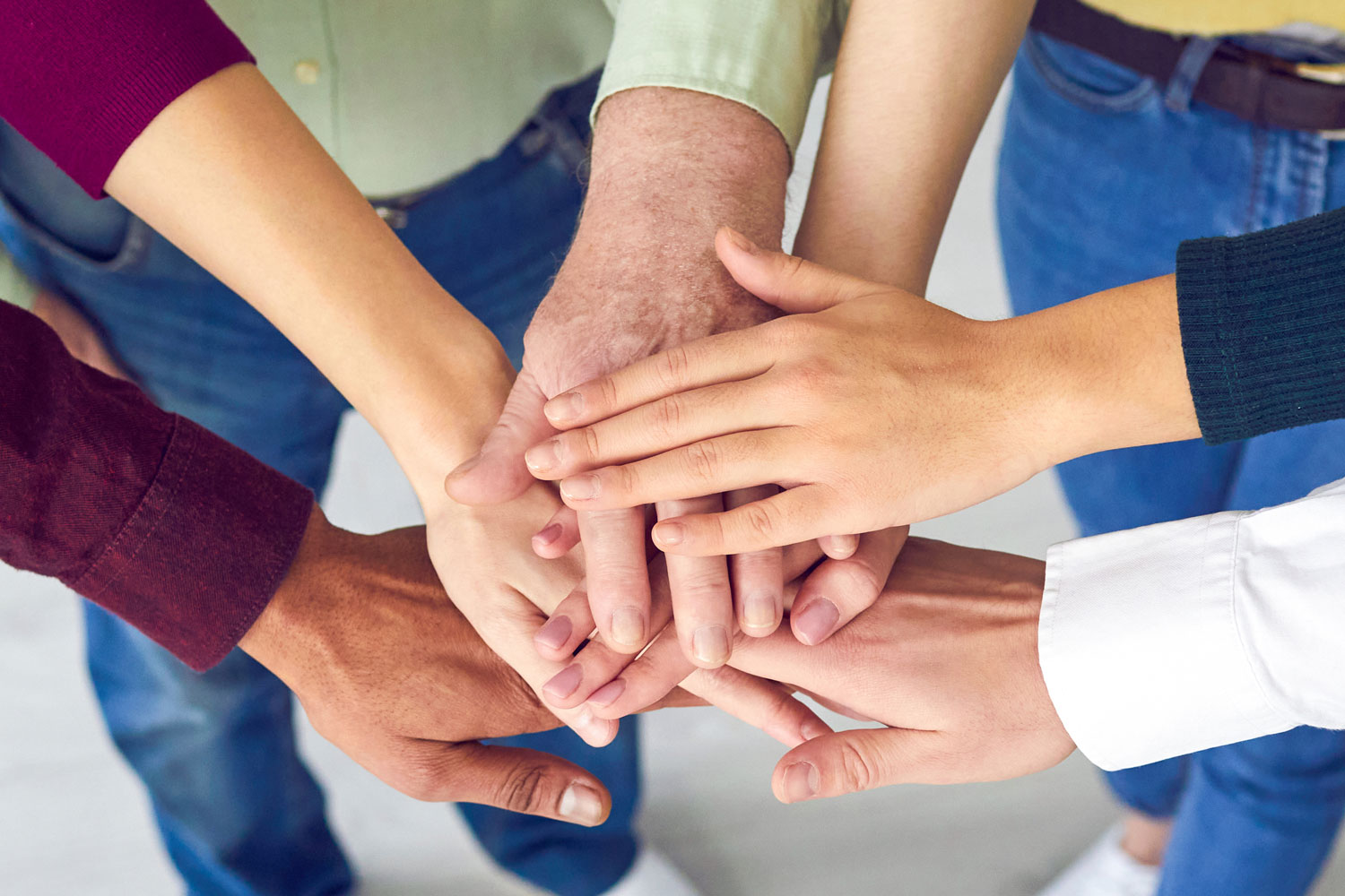 Handsstackedtogethersymbolizingteamworkunityandfosteringpositivesocialimpact